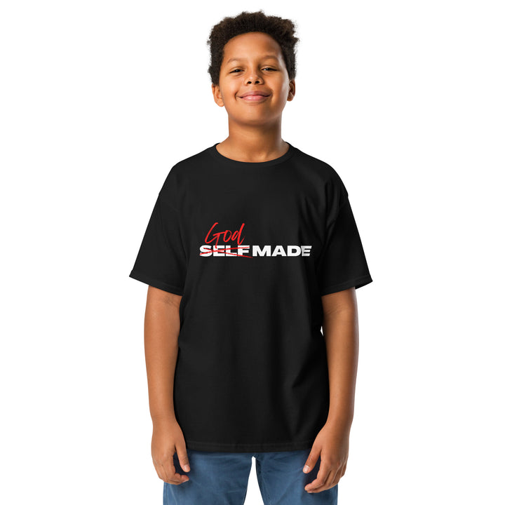 Child wearing a black t-shirt with 'God Self Made' text on a white background