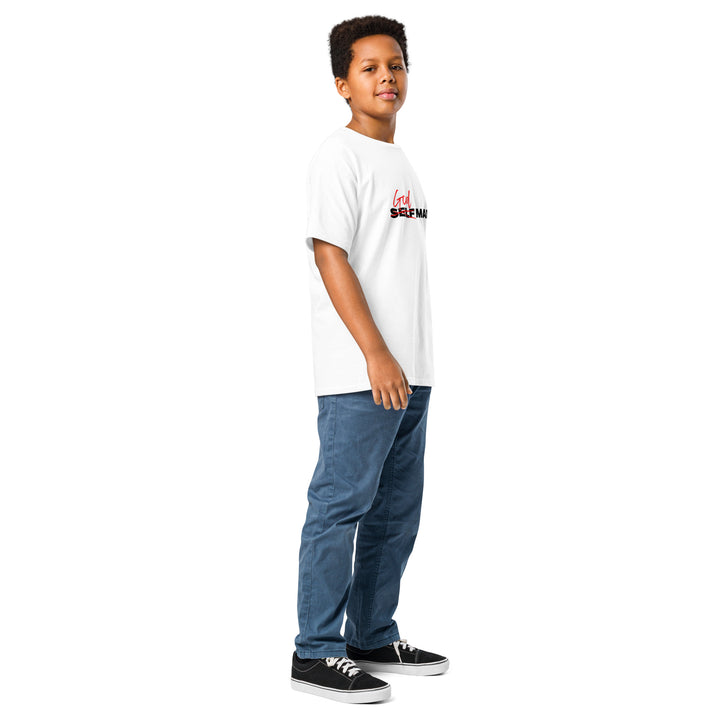 Child wearing a god made white t-shirt with text and blue jeans on a white background