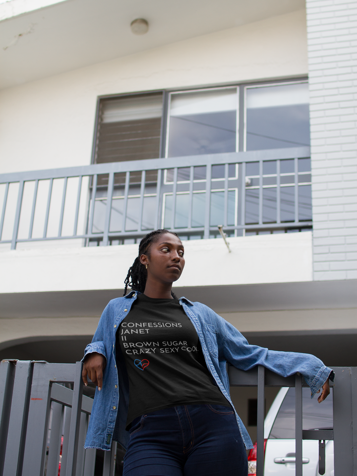 Black woman outside of her home wearing R&B Essentials Tee – Love Clan Classics and blue geans 