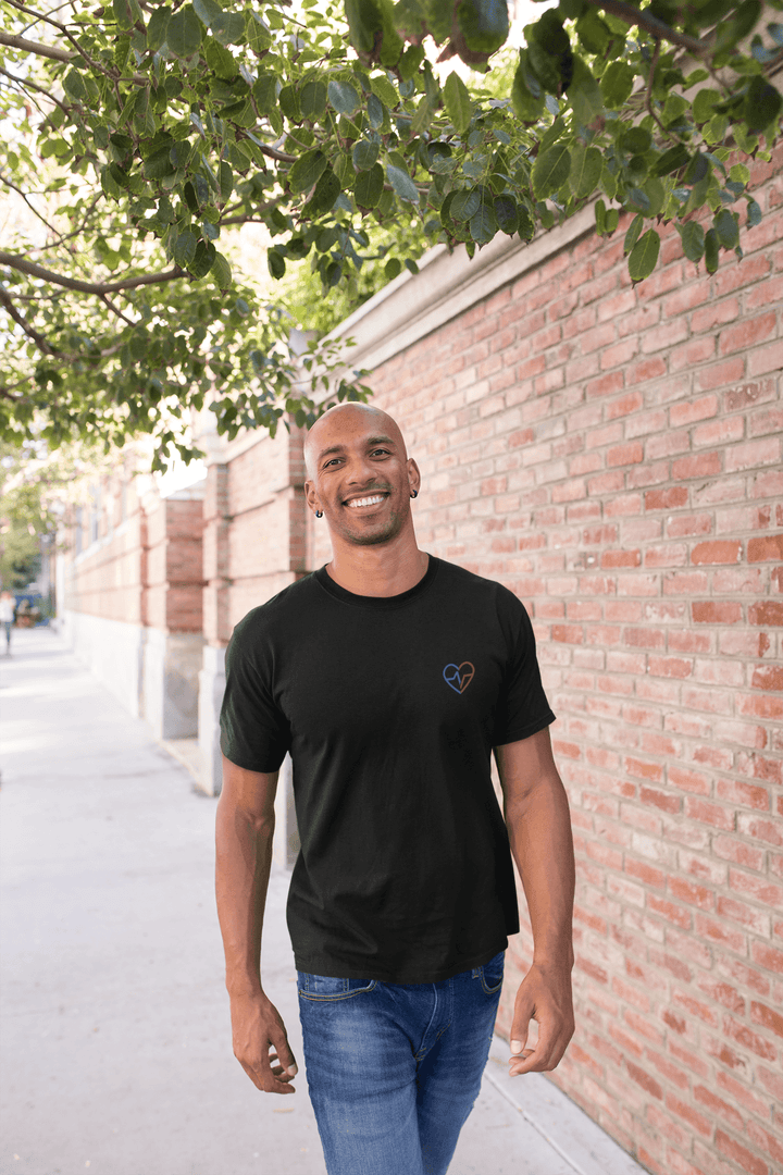 Black man walking down the street smiling, wearing the Love Clan Classic Embroidered T-Shirt by Norian Love