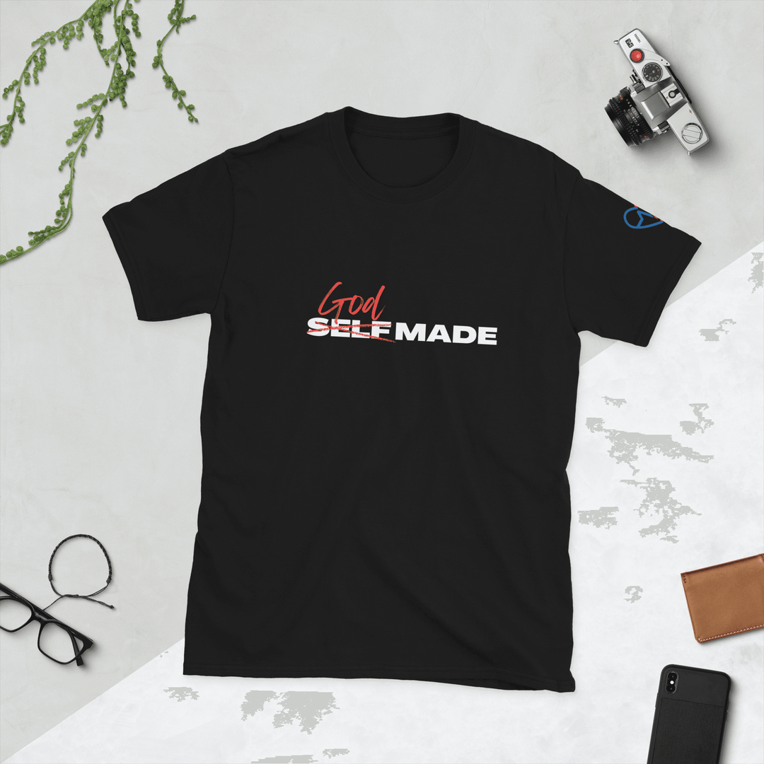 God Made Shirt – Christian T-shirt for Faith flat lay next to the camera and glasses 