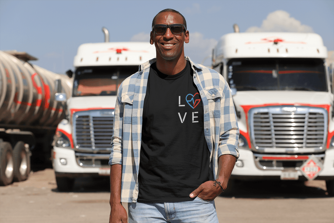 Black Trucker wearing Love Season T - by Norian Love in front of 18 wheeeler turcks 