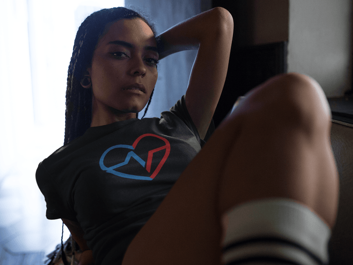 Black woamn layign back relaxing in Love Clan Signature Tee