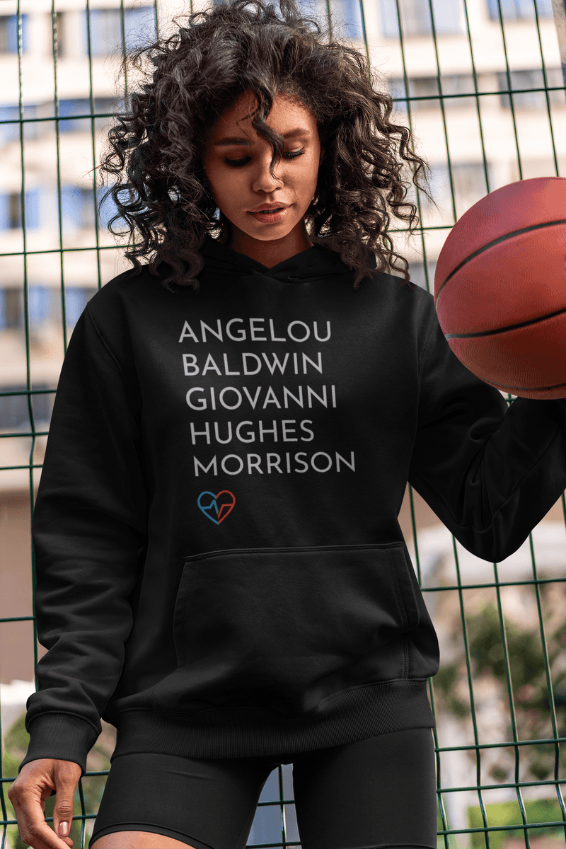 African American woman wearing the GOATs Hoodie featuring Angelou, Baldwin, Giovanni, Hughes, and Morrison while holding a basketball.