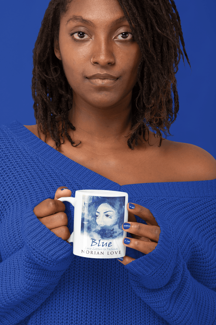 Black woman in a blue sweater holding the Blue Love mug featuring the cover art from Love Letters to Fatima.