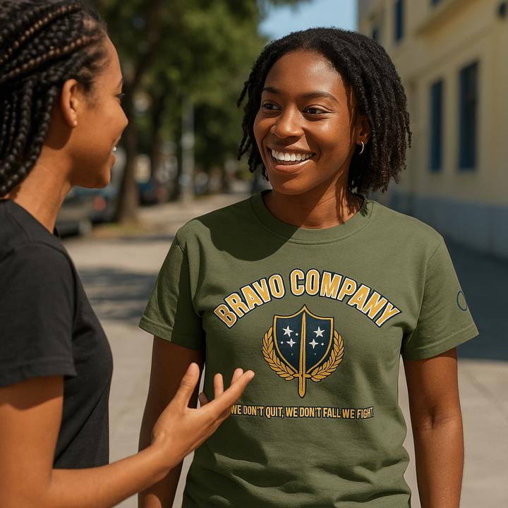 Two Black women talking outside, one wearing a military green Bravo Company shirt
