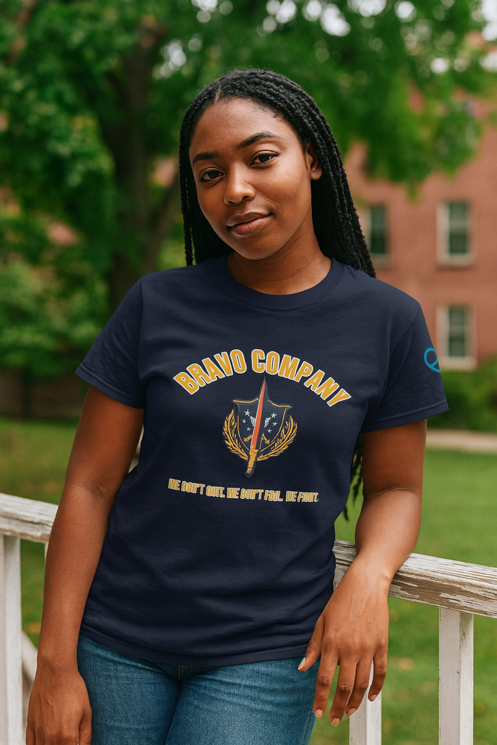 Black woman wearing a navy Bravo Company shirt leaning on an outdoor railing
