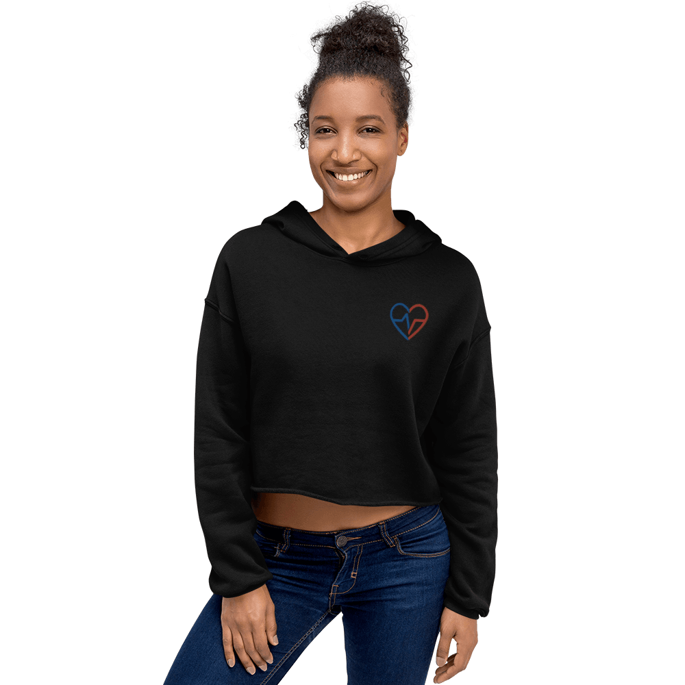 Black woman wearing Love Clan black crop top hoodie with small red and blue heart logo
