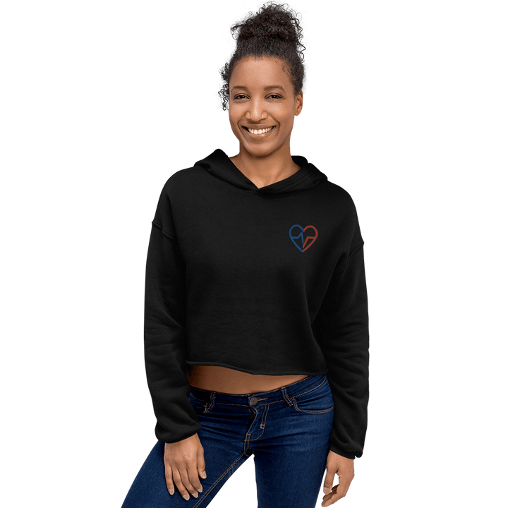 Black woman wearing Love Clan black crop top hoodie with small red and blue heart logo