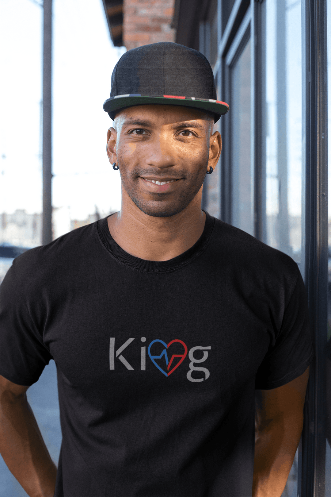 Black man wearing Love Is King modern men’s graphic motivational tee outside