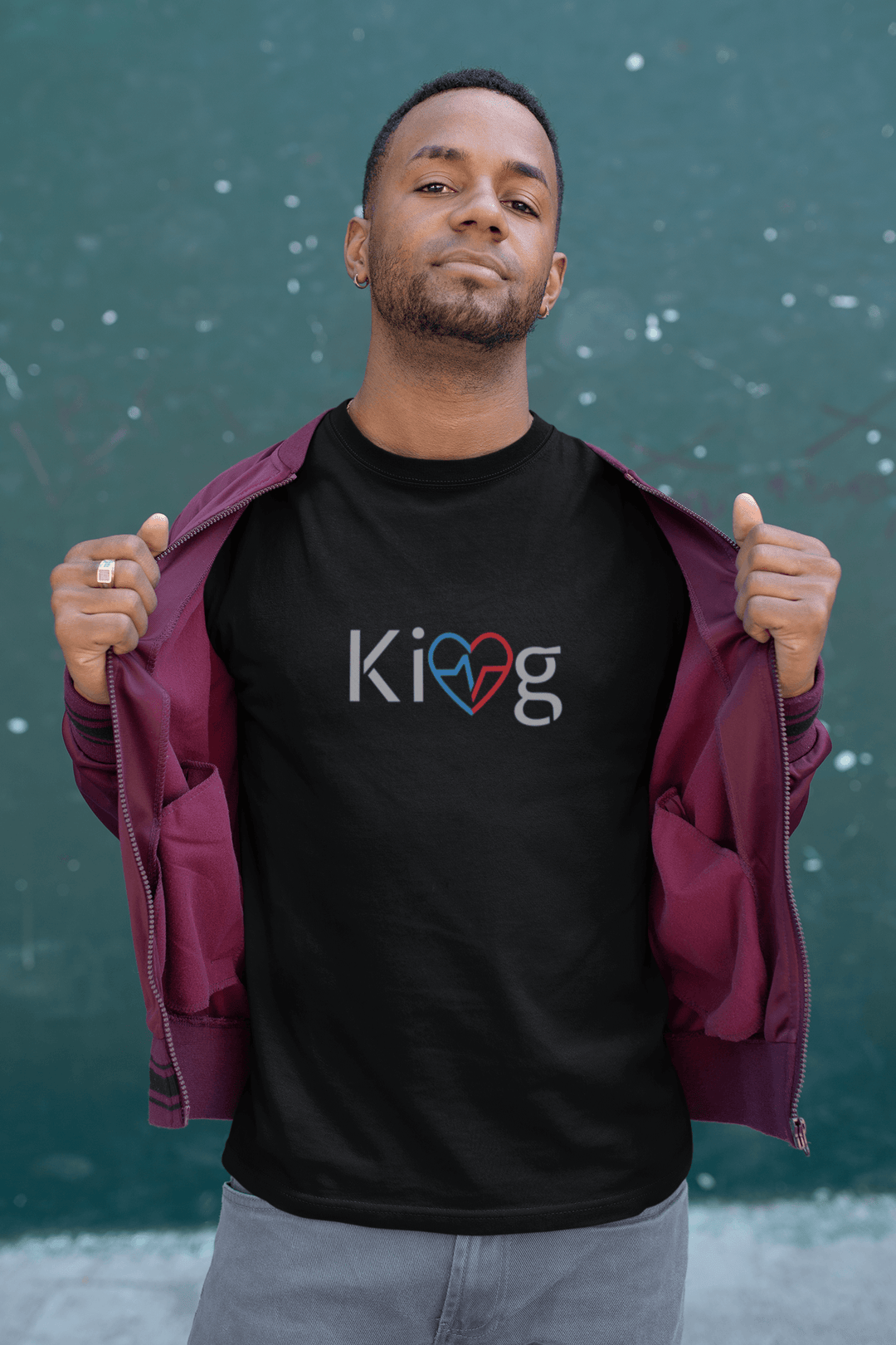 Man wearing Love Is King shirt with jacket open