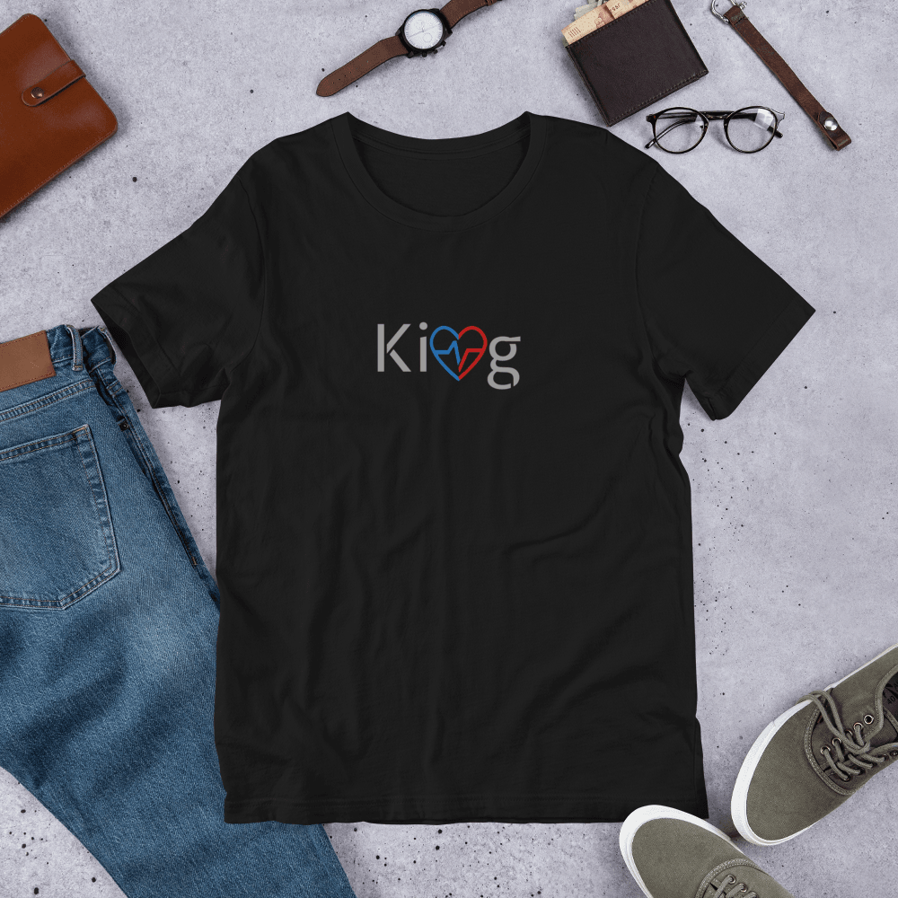 Love Is King men’s motivational t-shirt flatlay on concrete