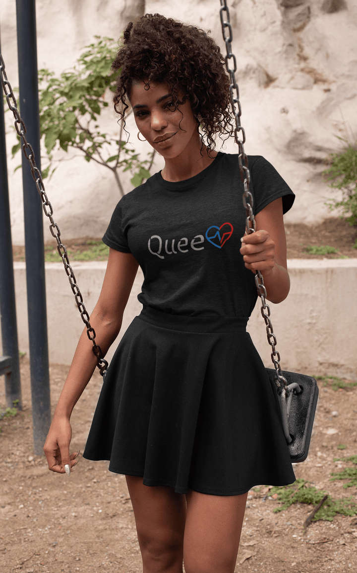 Black woman sitting on a swing while wearing the Love Is Queen shirt.
