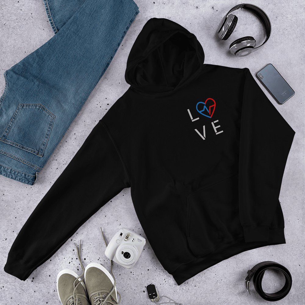Black-owned streetwear black Love Season Hoodie featuring the minimalist Love Clan emblem, photographed in a flat lay with jeans, camera, and accessories.