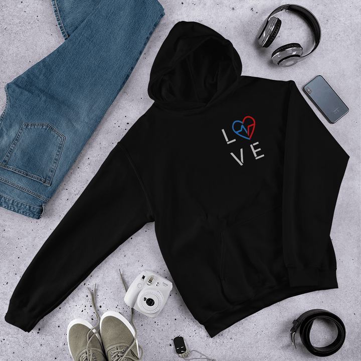 Black-owned streetwear black Love Season Hoodie featuring the minimalist Love Clan emblem, photographed in a flat lay with jeans, camera, and accessories.