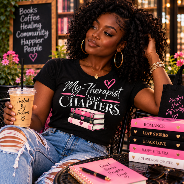 Black woman with natural curls wearing My Therapist Has Chapters women's T-shirt at an outdoor bookstore cafe