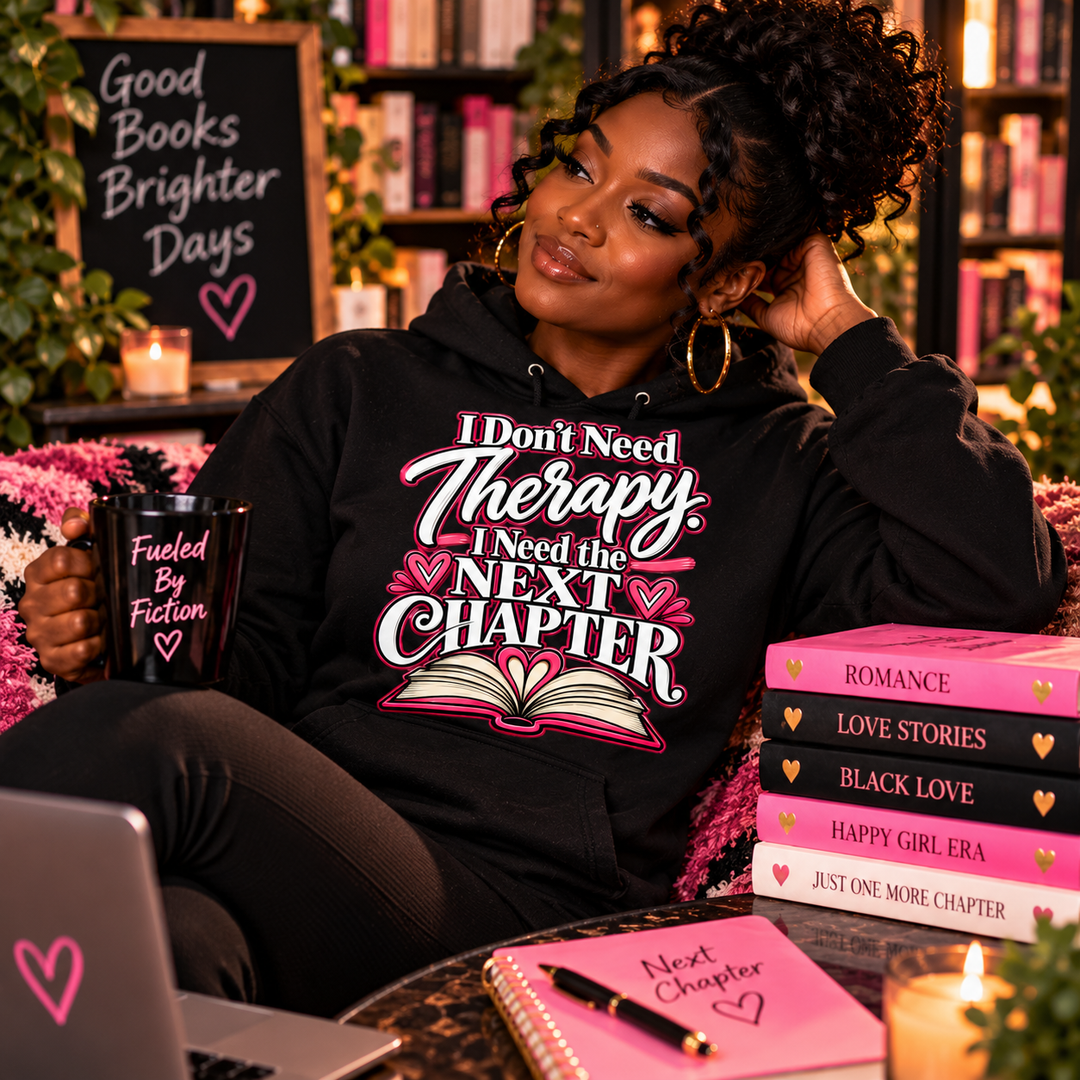 Dark-skinned woman wearing I Don't Need Therapy I Need the Next Chapter black hoodie in cozy reading lounge