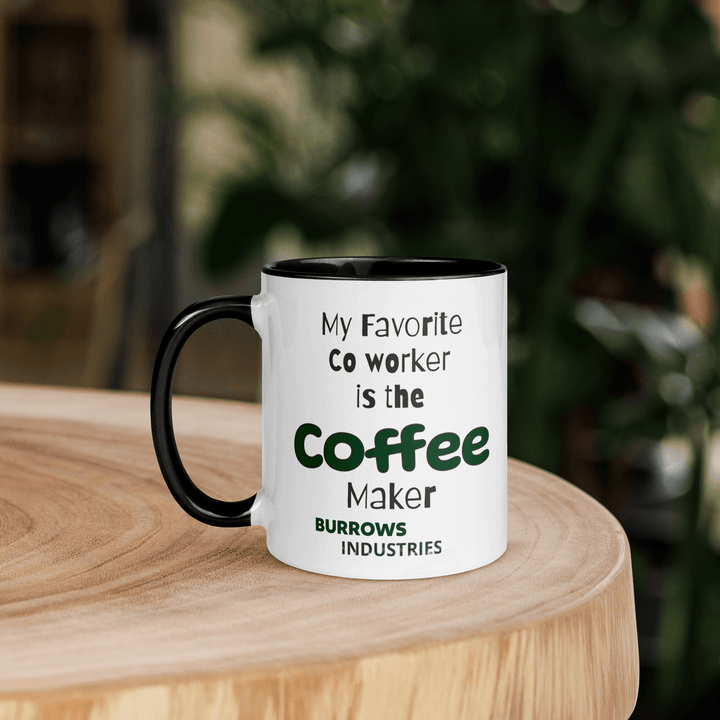 White ceramic mug with black interior and handle displaying the Burrows Industries slogan stating the coffee maker is the favorite co-worker.