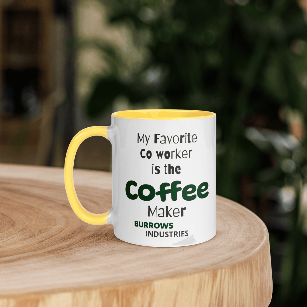 White ceramic mug with yellow interior and handle displaying the Burrows Industries slogan stating the coffee maker is the favorite co-worker.