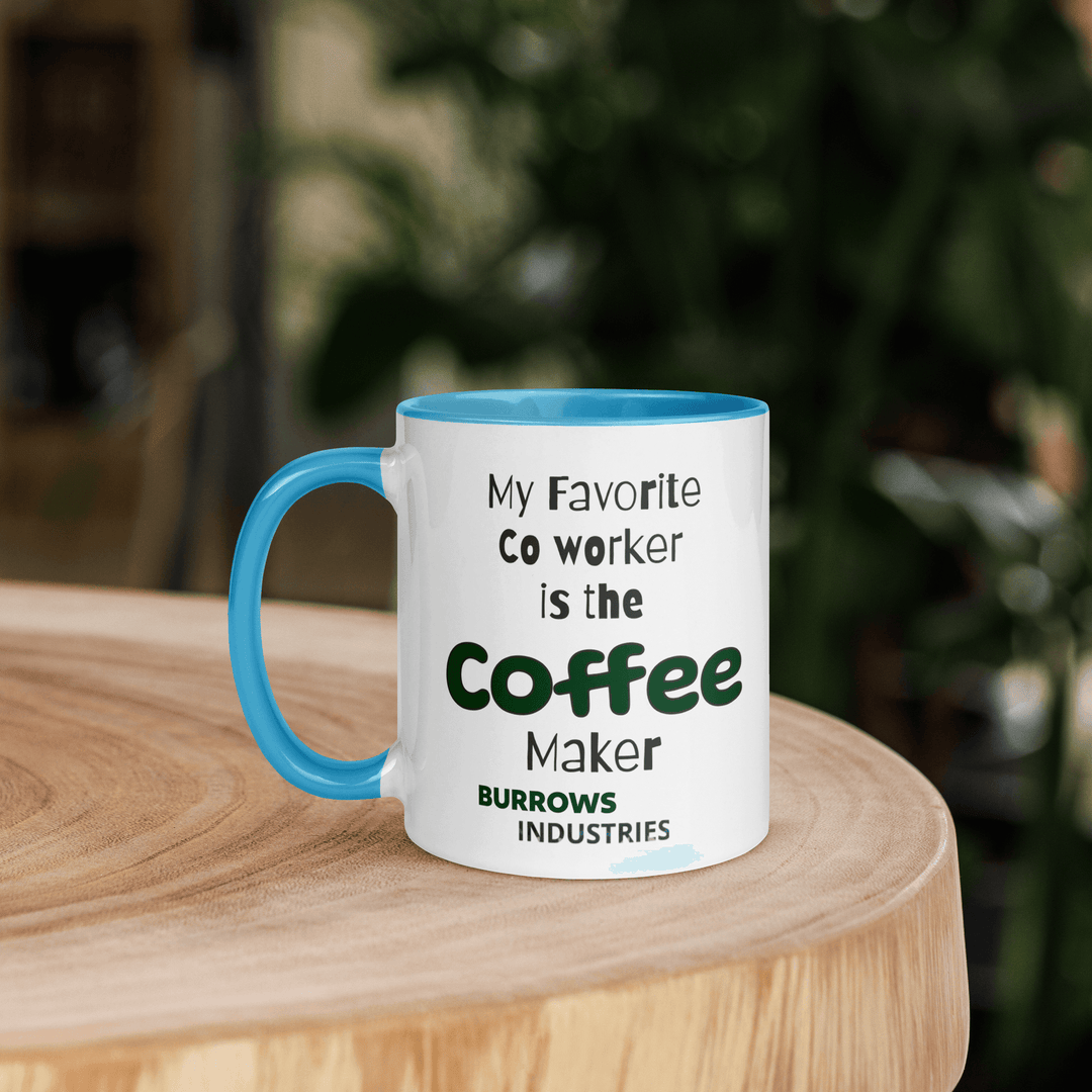 White ceramic mug with light blue interior and handle displaying the Burrows Industries slogan stating the coffee maker is the favorite co-worker.