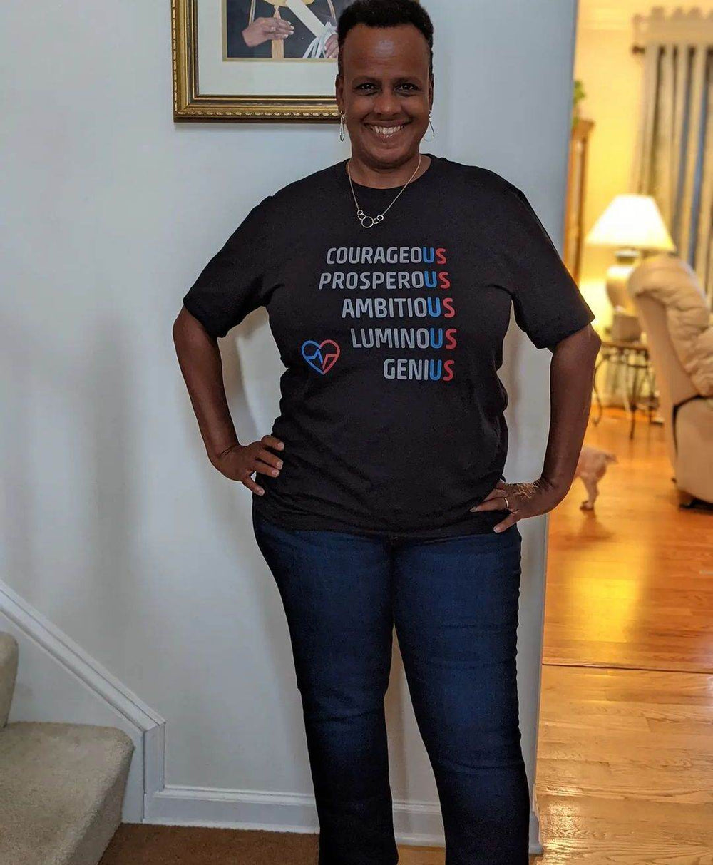 Customer wearing black The US Tee with motivational design indoors