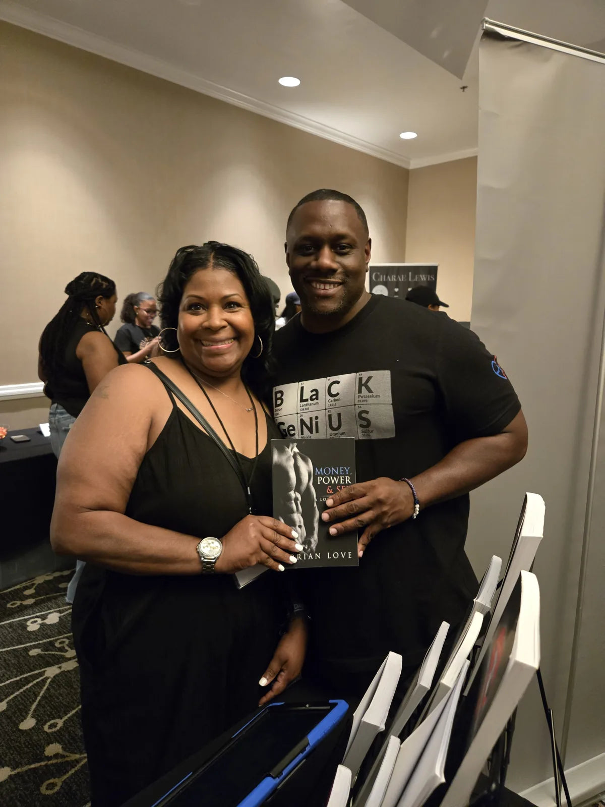 Norian Love with a reader and a copy of Money, Power & Sex.