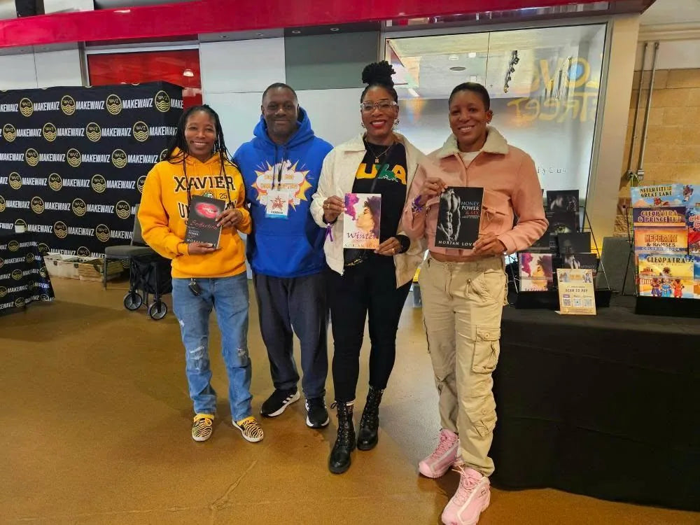 Norian Love with three readers holding Seduction, Winter, and Money, Power & Sex at a book table.